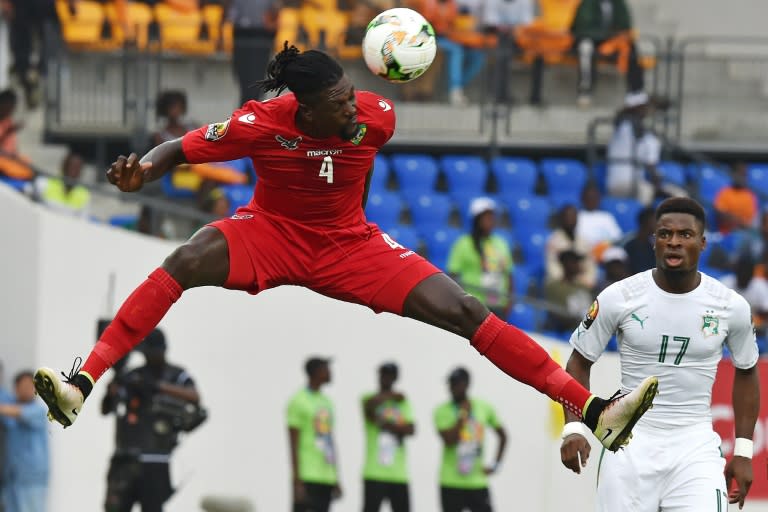 Togo's forward Emmanuel Adebayor (L) heads the ball next to Ivory Coast's defender Serge Aurier on January 16, 2017