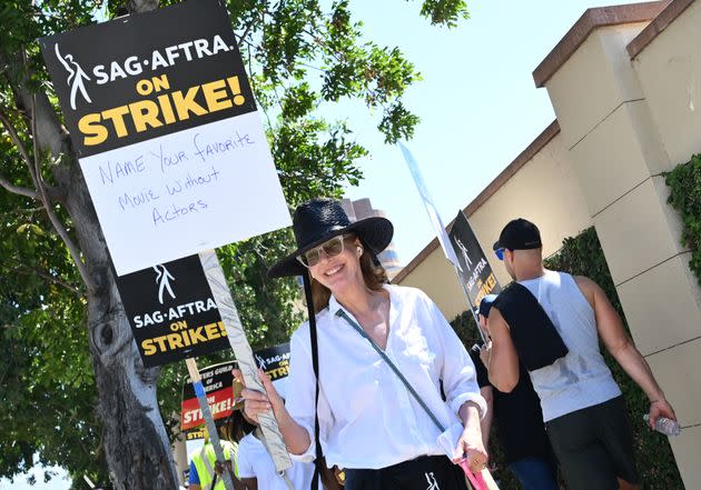 Actor Allison Janney joins the picket line outside Warner Bros. Studios. Her sign reads, 