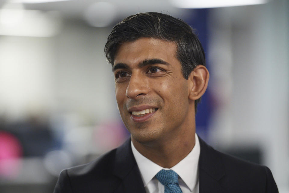 Britain's Chancellor of the Exchequer Rishi Sunak visits the headquarters of Octopus Energy in London, Monday Oct. 5, 2020. They visited the startup company to promote the company's plan to create 1,000 new technology jobs across sites in London, Brighton, Warwick and Leicester, and a new tech hub in Manchester. (Leon Neal/Pool via AP)