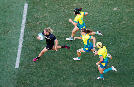 Rugby Sevens - Gold Coast 2018 Commonwealth Games - Women's Gold Medal Match - Australia v New Zealand - Robina Stadium - Gold Coast, Australia - April 15, 2018. Kelly Brazier (L) of New Zealand runs to score a try. REUTERS/David Gray