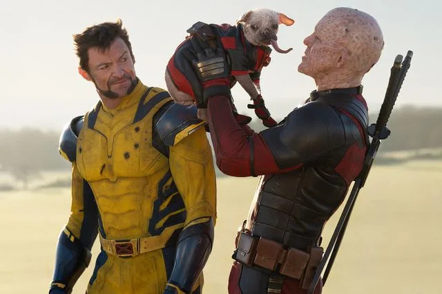 <p>Jay Maidment/20th Century Studios/MARVEL</p> From left: Hugh Jackman, Peggy and Ryan Reynolds in 'Deadpool & Wolverine'