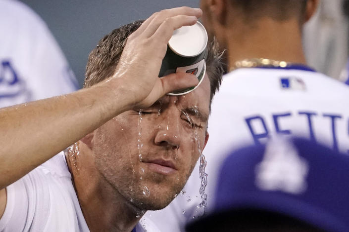 Los Angeles Dodgers starting pitcher Tyler Anderson pours water on his face prior to a baseball game against the San Francisco Giants Tuesday, Sept. 6, 2022, in Los Angeles. (AP Photo/Mark J. Terrill)