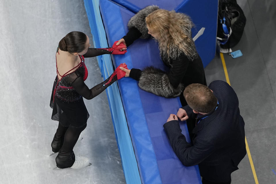 Kamila Valieva, of the Russian Olympic Committee, talks to her coach Eteri Tutberidze, right, before competing in the women's free skate program during the figure skating competition at the 2022 Winter Olympics, Thursday, Feb. 17, 2022, in Beijing. (AP Photo/Jeff Roberson)