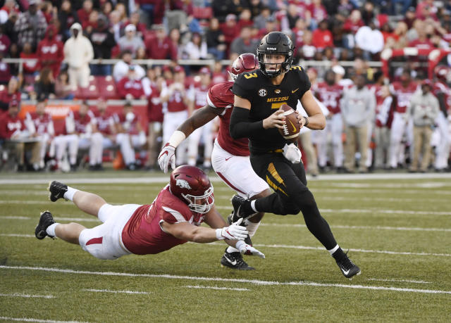 Missouri quarterback Drew Lock scrambles out of the pocket as he runs the ball against Arkansas during the second half of an NCAA college football game Friday, Nov. 24, 2017 in Fayetteville, Ark. (AP Photo/Michael Woods)