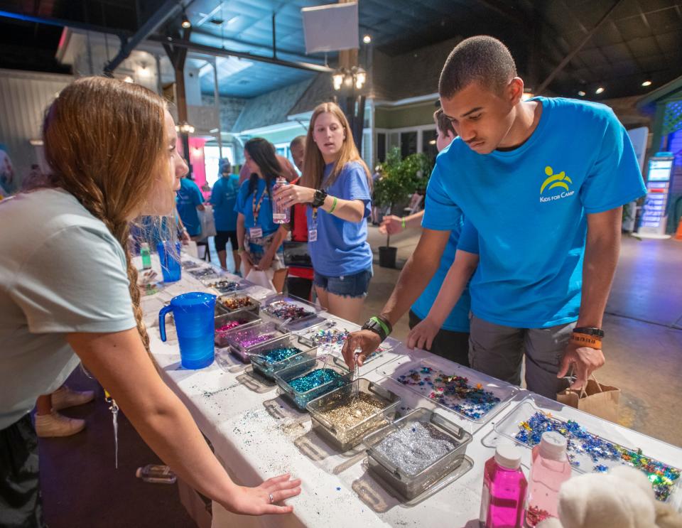 Volunteer Ava Hale, 15, of the Bear Family Foundation, left, helps Ruurd Fletcher make a sensory bottle during Autism Pensacola’s Sensory Street event at the Museum of Commerce in downtown Pensacola on Thursday, June 24, 2021. The second annual Autism Pensacola Sensory Street is being held on June 24-25, 2022 from 9 a.m. to 2 p.m. at the Historic Pensacola Museum of Commerce on 201 E. Zaragoza St.