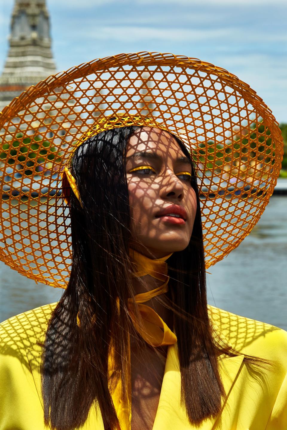 “I was rejected at castings a lot, not only for my skin tone, but because I am trans. Many trans models tell me that my winning [The Face Thailand] has opened doors for them, but it has been very tough,” says Candy Kulchaya. Her yellow liner was “inspired by the marigold flower that we use here for garlands,” says Barose. He used NYX Professional Makeup EpicWear Liner Stick in Cosmic Yellow, and then, to add more intensity, layered matching yellow powder eye shadow over it using a dampened liner brush. Irada top. Stylist's own hat.