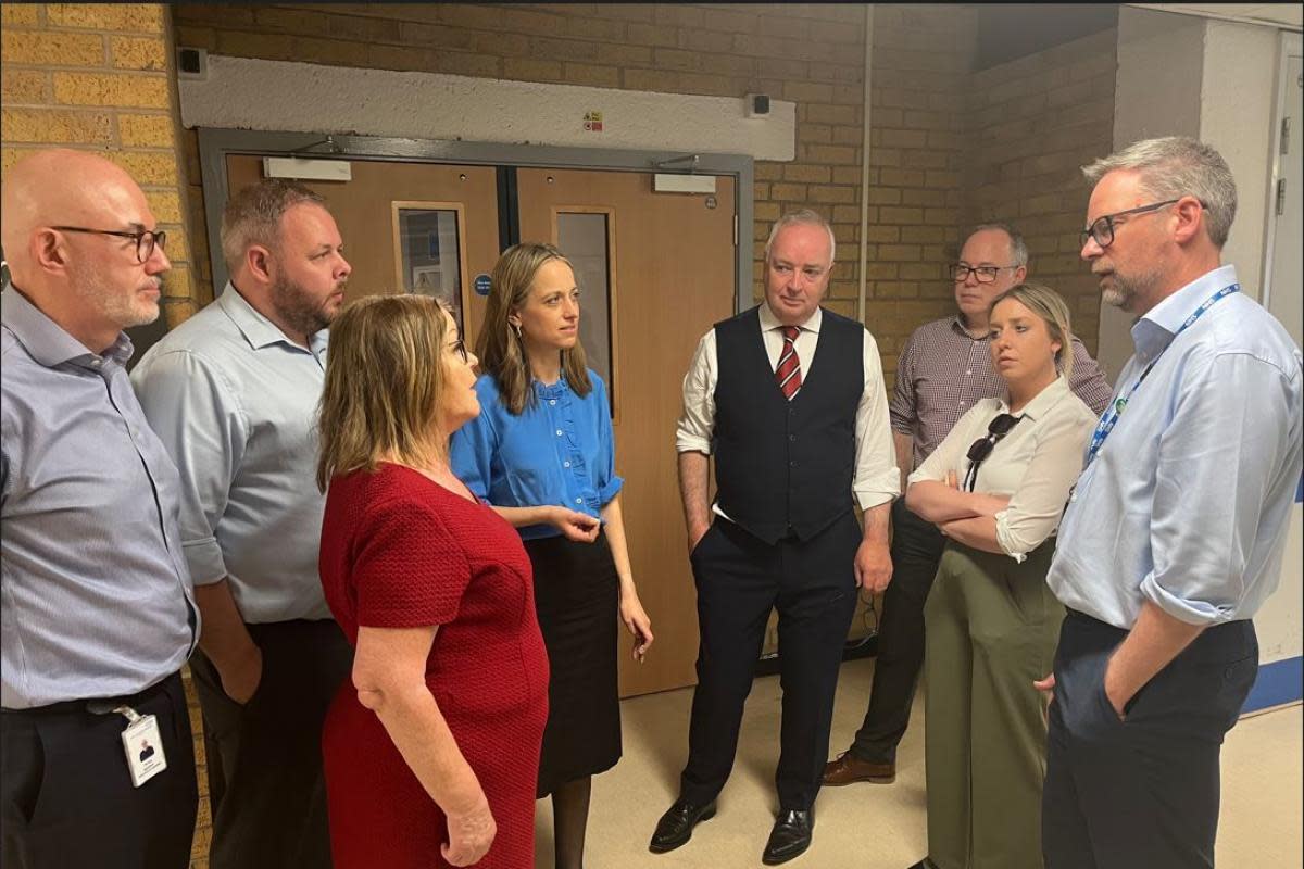 Health minister Helen Whately (in the blue shirt in the centre) discusses the challenges facing the Royal Blackburn Hospital with the MPs and senior staff