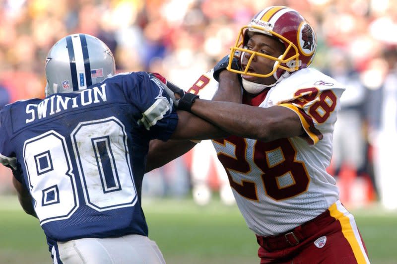 Former Pro Bowl cornerback Darrell Green (R) holds multiple franchise records for the Washington Commanders. File Photo by Roger L. Wollenberg/UPI