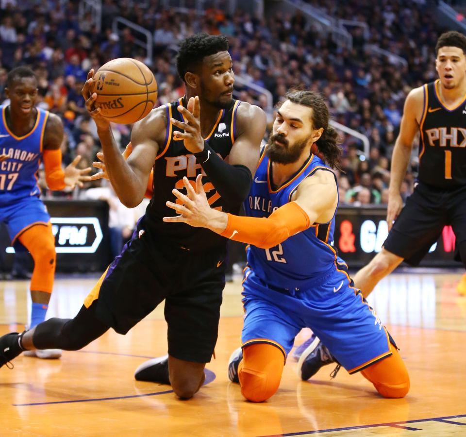 Phoenix Suns center Deandre Ayton steals the ball from Oklahoma City Thunder center Steven Adams on Dec. 28 at Talking Stick Resort Arena in Phoenix.