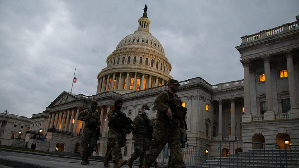 Members of the U.S. National Guard walk outside the U.S. Capitol in Washington, D.C. on Sunday, Jan. 1