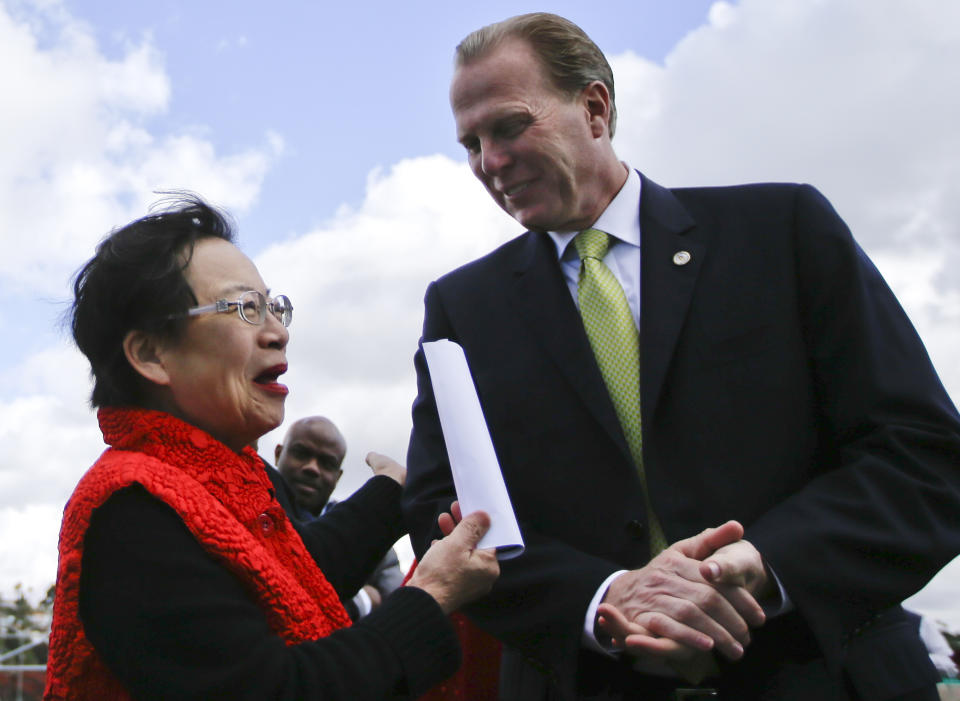 In a Monday, Feb. 3, 2014 photo, San Diego mayoral candidate Kevin Faulconer engages in conversation with supporter Lilly Cheng during a campaign event, in San Diego. Faulconer easily topped a field of 11 candidates in a first round of voting by dominating in wealthier neighborhoods north of the freeway. (AP Photo/Lenny Ignelzi)