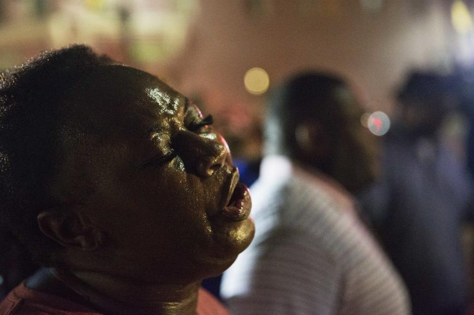 Lisa Doctor joins a prayer circle down the street from the Emanuel AME Church. (AP Photo/David Goldman)