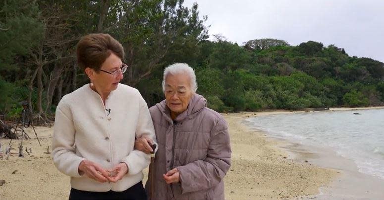 CBS News senior foreign correspondent Elizabeth Palmer walks along a beach on the Japanese island of Ishigaki, speaking with lifelong resident Setsuko Yamazato, 87. / Credit: CBS News/Randy Schmidt