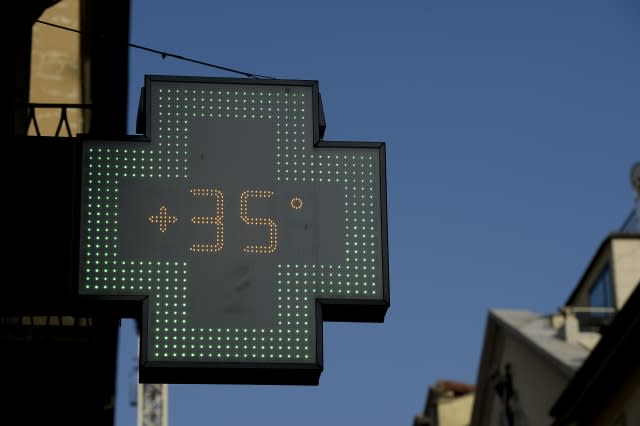A sign of a pharmarcy shows the temperature during the...