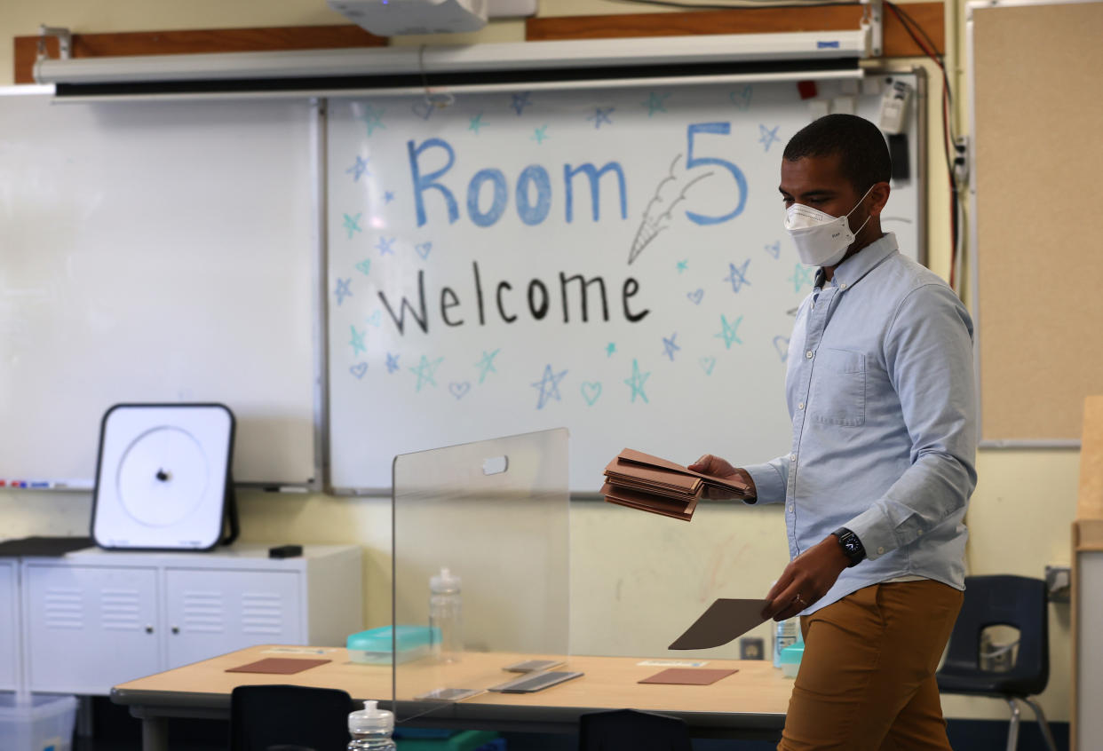 SAN FRANCISCO, CALIFORNIA - APRIL 09: Bryant Elementary School kindergarten teacher Chris Johnson sets up his classroom on April 09, 2021 in San Francisco, California. The San Francisco Unified School District is preparing to gradually return students back to classrooms next week. (Photo by Justin Sullivan/Getty Images)