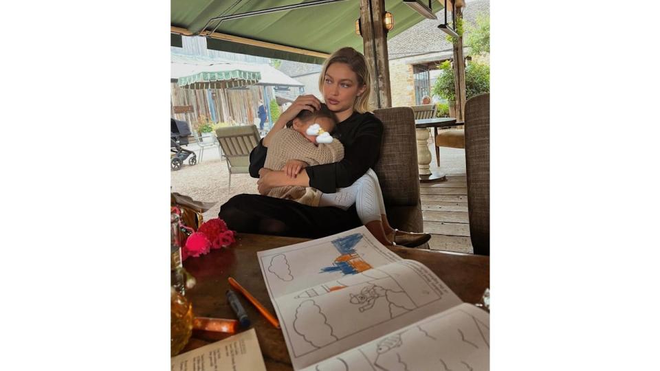 Gigi cradled her daugher during a rainy day at Soho Farmhouse