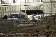 Police vans are seen outside the headquarters of the Zhongzhi Enterprise Group Co. in Beijing, Tuesday, Nov. 28, 2023. A top executive of China Evergrande's electric vehicle company has been detained by police in the latest sign of trouble for the world's most heavily indebted property developer. That followed news over the weekend that Zhongzhi Enterprise Group, a major shadow bank in China that has lent billions in yuan (dollars) to property developers, filed for bankruptcy liquidation after it was unable to pay its debts. (AP Photo/Ng Han Guan)