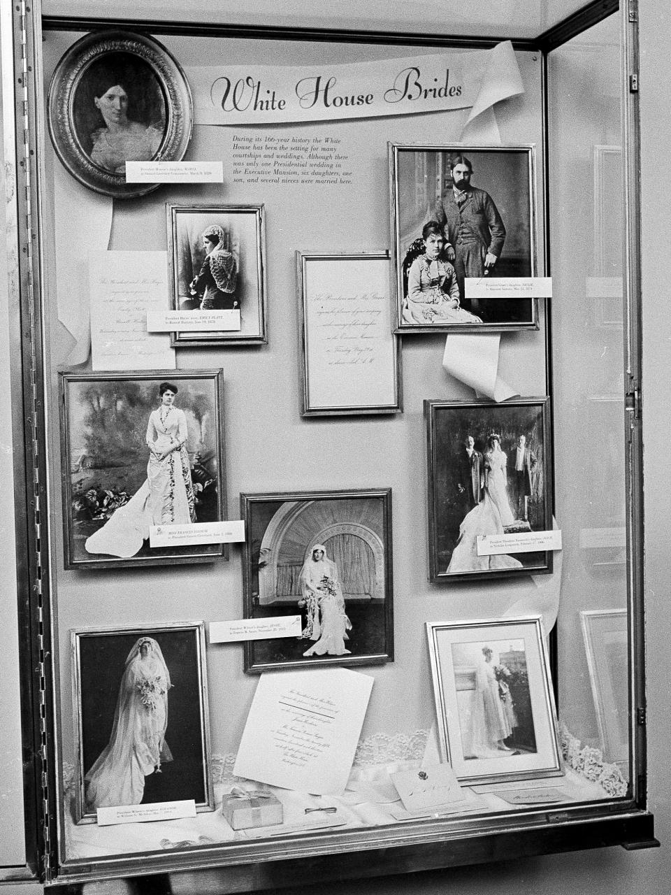 FILE - Photographs of brides married in the White House are displayed in the executive mansion in a glass-enclosed case in Washington, Aug. 1, 1966 prior to Saturday wedding of Luci Baines Johnson, President Johnson's youngest daughter. Down the left side of the frame, top the bottom, are: President James Monroe's daughter, Maria; President Rutherford B. Haye's niece, Emily Platt, Miss Frances Folsom, married to President Grover Cleveland; and President Woodrow Wilson's daughter, Eleanor. At center, President Wilson's daughter, Jessie. At right, top to bottom: President U.S. grant's daughter, Nellie; President Theodore Roosevelt's daughter, Alice; and President Wilson's niece, Alice Wilson. (AP Photo)