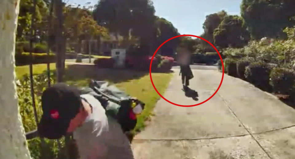 The 'shaking' 11-year-old girl, circled, approaches Ryan Ghambari at his front door after the 'attempted abduction'.