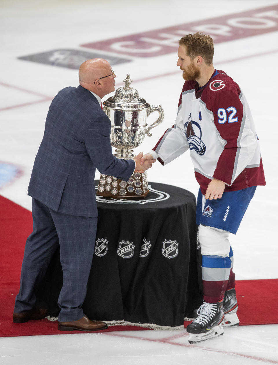 Colorado Avalanche's Gabriel Landeskog (92) is presented the Campbell Conference Bowl from Bill Daley, Deputy Commissioner, after defeating the Edmonton Oilers during overtime NHL hockey conference finals action in Edmonton, Alberta, on Monday, June 6, 2022. The Avalanche won the game 6-5, to take the series. (Amber Bracken/The Canadian Press via AP)