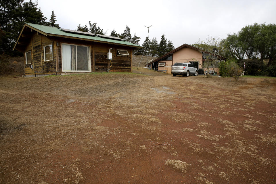 Miki Brand's house is shown on Native Hawaiian homestead land near Waimea, Hawaii, Wednesday, Aug. 4, 2021. Brand's property narrowly escaped flames from the state's largest-ever wildfire that scorched the area. (AP Photo/Caleb Jones)