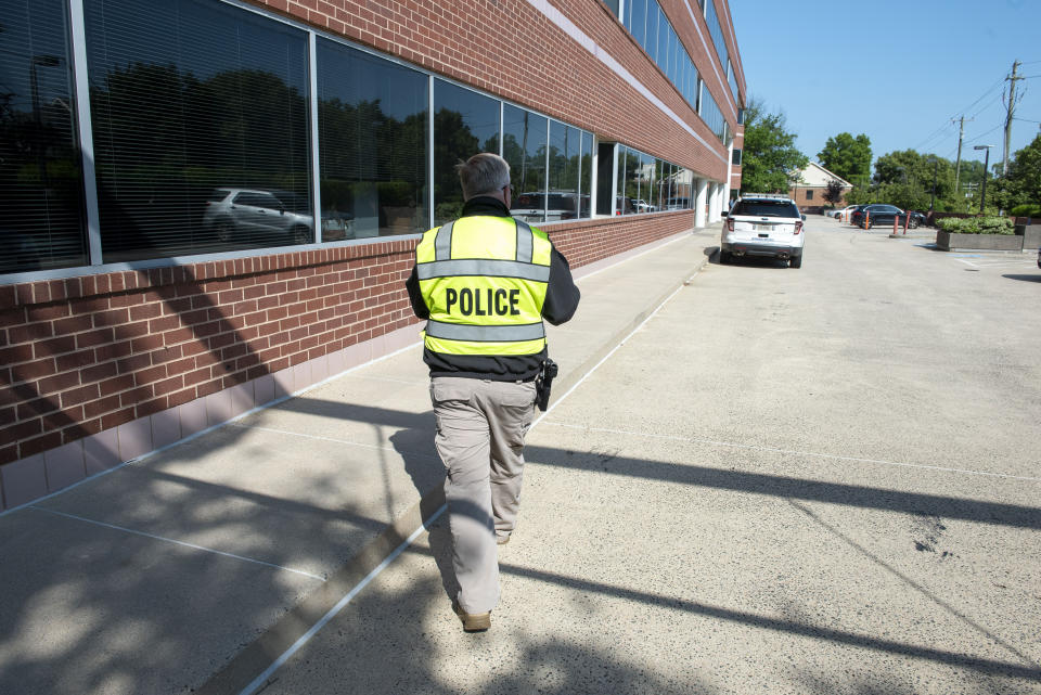 Law enforcement investigate outside the Fairfax, Va., office building where police say a man wielding a baseball bat attacked two staffers for U.S. Rep. Gerry Connolly, D-Va., on Monday, May 15, 2023. Fairfax City Police in northern Virginia said in a tweet that a suspect is in custody and the victims are being treated for injuries that are not life-threatening. (AP Photo/Cliff Owen)