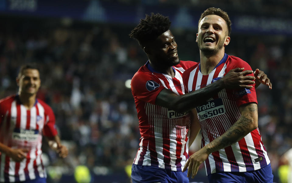 Atletico's Saul Niguez, right, celebrates after scoring his side's third goal during the UEFA Super Cup final soccer match between Real Madrid and Atletico Madrid at the Lillekula stadium in Tallinn, Estonia, Wednesday, Aug. 15, 2018. (AP Photo/Mindaugas Kulbis)