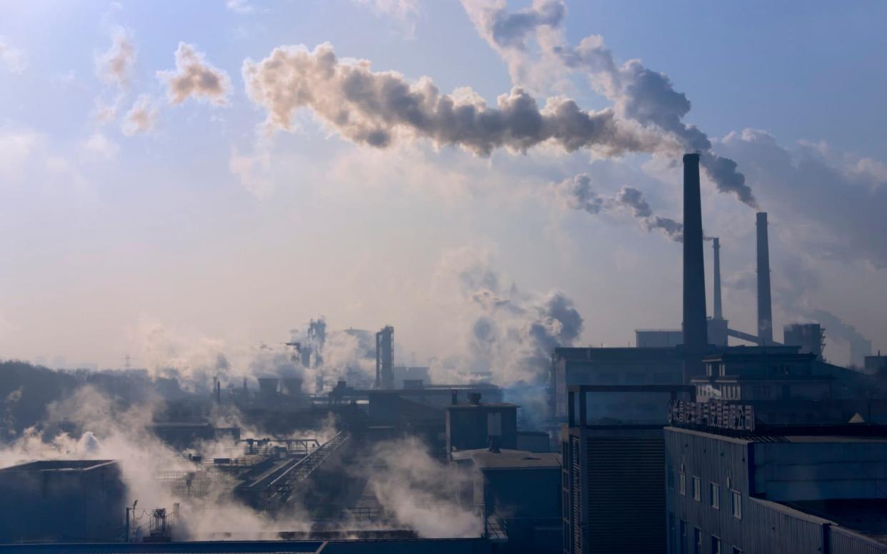 Chinese factory chimneys emitting smoke. - Corbis Documentary