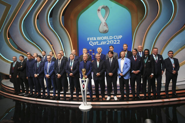 Coaches pose for a group photo following the 2022 soccer World Cup draw at the Doha Exhibition and Convention Center in Doha, Qatar, Friday, April 1, 2022. (AP Photo/Hussein Sayed)