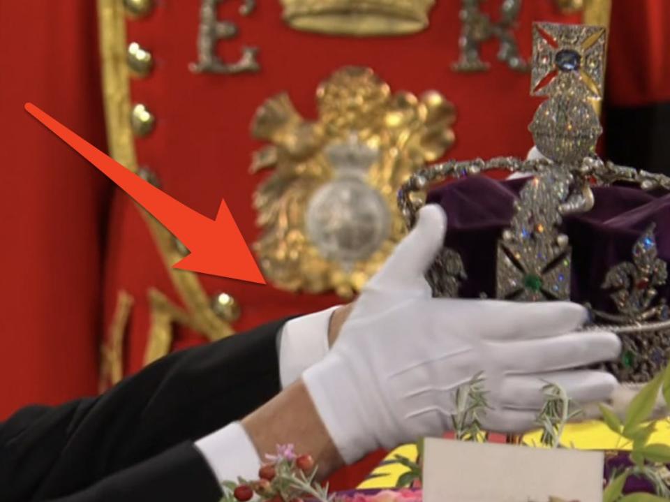 crown being removed from queen's coffin during funeral services