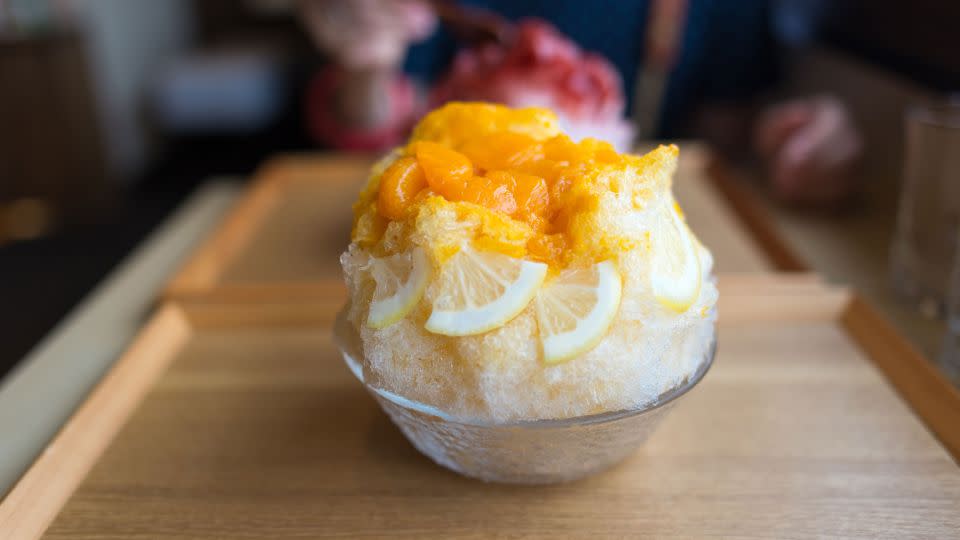 Mixed citrus syrup is poured over shaved ice in this Japanese kakigori. - hazelog/Moment Open/Getty Images