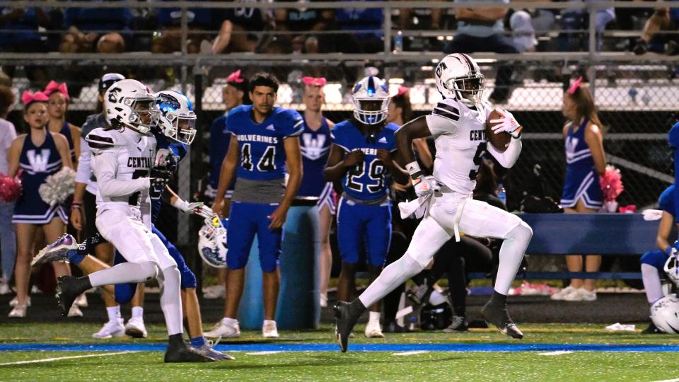 Palm Beach Central receiver Waden Charles runs down the far sideline, breaking for the end zone past Wellington defenders in the Wellington Cup on Oct. 27, 2023.