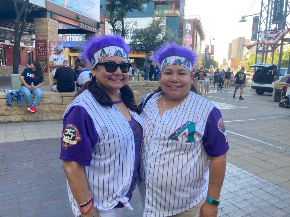 Diamondbacks fans Edna Moreno (left) and her sister Edith Megui prepare for Game 3 in Arizona's playoff series with the Los Angeles Dodgers on Oct. 11, 2023, at Chase Field in Phoenix.