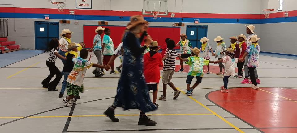 Dance instructor Mary Allgire leading an old time dance;