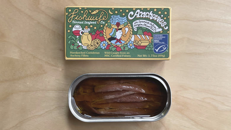 box and open tin of anchovies 