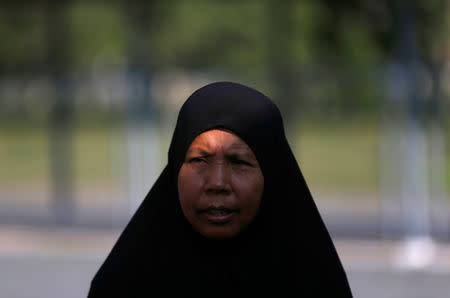 A Cambodian Muslim woman walks at the the Extraordinary Chambers in the Courts of Cambodia (ECCC), as she waits for a verdict on the former Khmer Rouge head of state Khieu Samphan and former Khmer Rouge leader ''Brother Number Two'' Nuon Chea, on the outskirts of Phnom Penh, Cambodia, November 16, 2018. Reuters/Samrang Pring