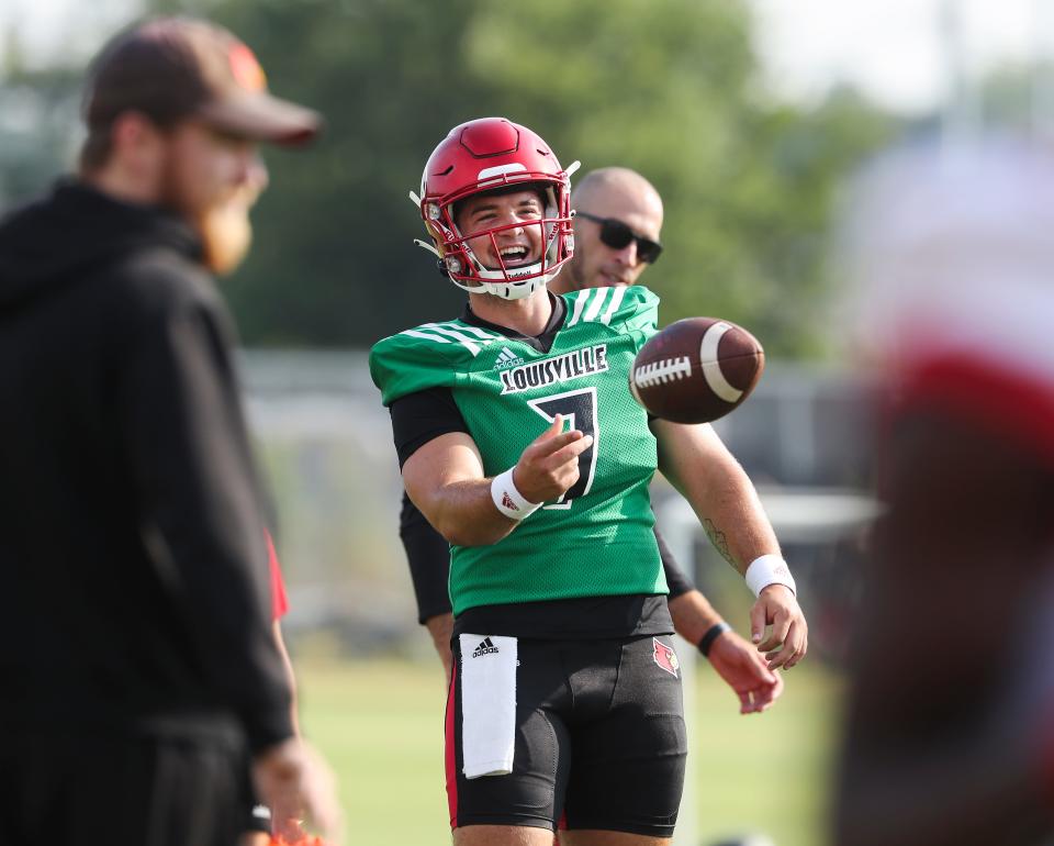 U of L QB Brock Domann (7) tosses the football during a break in practice on fan day outside Cardinal Stadium in Louisville, Ky. on Aug. 8, 2021.  