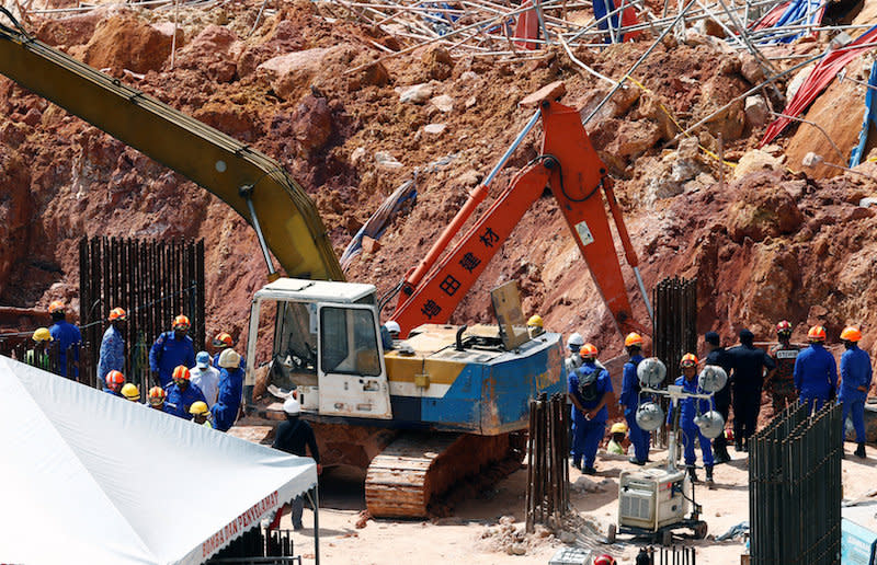 Rescue workers search for victims of a landslide at a construction site in Tanjung Bungah, George Town October 22, 2017. — Reuters pic