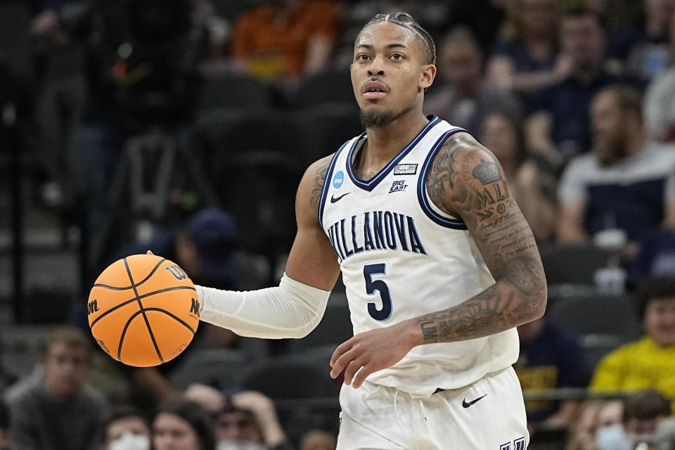 FILE - Villanova guard Justin Moore brings the ball down court against Michigan during the second half of a college basketball game in the Sweet 16 round of the NCAA tournament, March 24, 2022, in San Antonio. Moore still has no timetable for a return as he recovers from a torn Achilles tendon suffered in the Elite Eight win over Houston. (AP Photo/David J. Phillip, File)