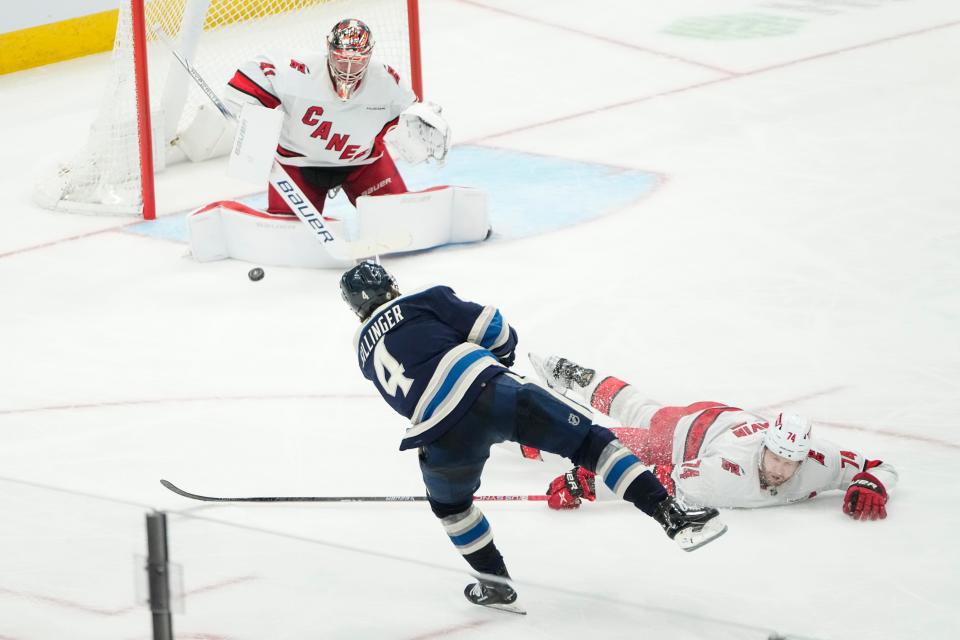 Feb 29, 2024; Columbus, Ohio, USA; Columbus Blue Jackets center Cole Sillinger (4) scores past Carolina Hurricanes defenseman Jaccob Slavin (74) and goaltender Spencer Martin (41) during the second period of the NHL hockey game at Nationwide Arena.