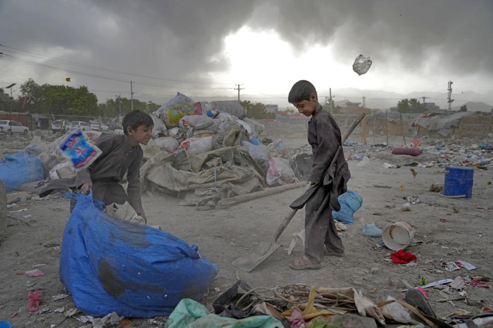 File - Two Afghan children collect recyclable material from a garbage dump in Kabul, Afghanistan, Sunday, May 8, 2022. (AP Photo/Ebrahim Noroozi, File)