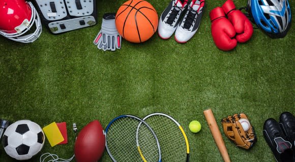 Sporting goods laid out on turf.