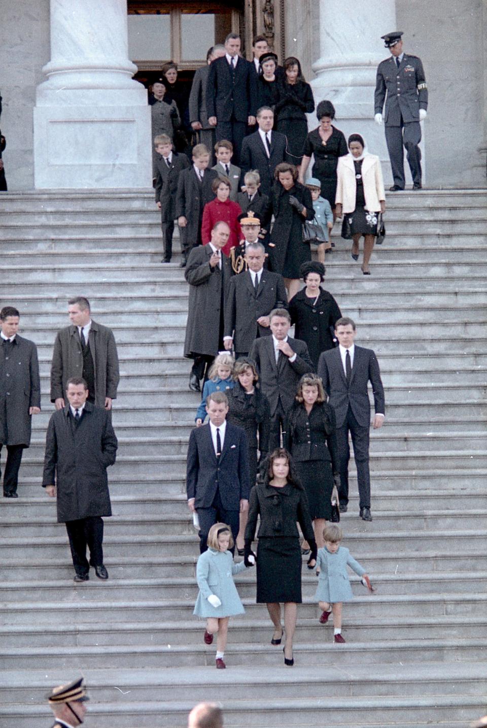 Jacqueline Kennedy holds the hands of her children, Caroline and John, as she leads the procession out of the U.S. Capitol for President John F. Kennedy's funeral on Nov. 25, 1963. Trailing behind them: Robert F. Kennedy, Peter Lawford and President Lyndon B. Johnson.