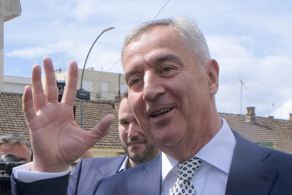 Pro-Western incumbent Milo Djukanovic waves after voting at a polling station in Montenegro's capital Podgorica, Sunday, April 2, 2023. Montenegrins are casting ballots on Sunday in a runoff presidential election that is a battle between a long-serving pro-Western incumbent and a newcomer promising changes in the small NATO member state in Europe that has been locked in political turmoil. (AP Photo/Risto Bozovic)