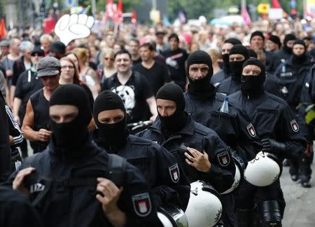 German police walk in line as they secure a demonstration during the G20 summit in Hamburg, Germany, July 8, 2017. REUTERS/Fabrizio Bensch