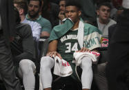 Milwaukee Bucks forward Giannis Antetokounmpo (34) sits on the bench after getting in foul trouble, during a NBA basketball game against the Brooklyn Nets, Saturday, Jan. 18, 2020 in New York. (AP Photo/Bebeto Matthews)