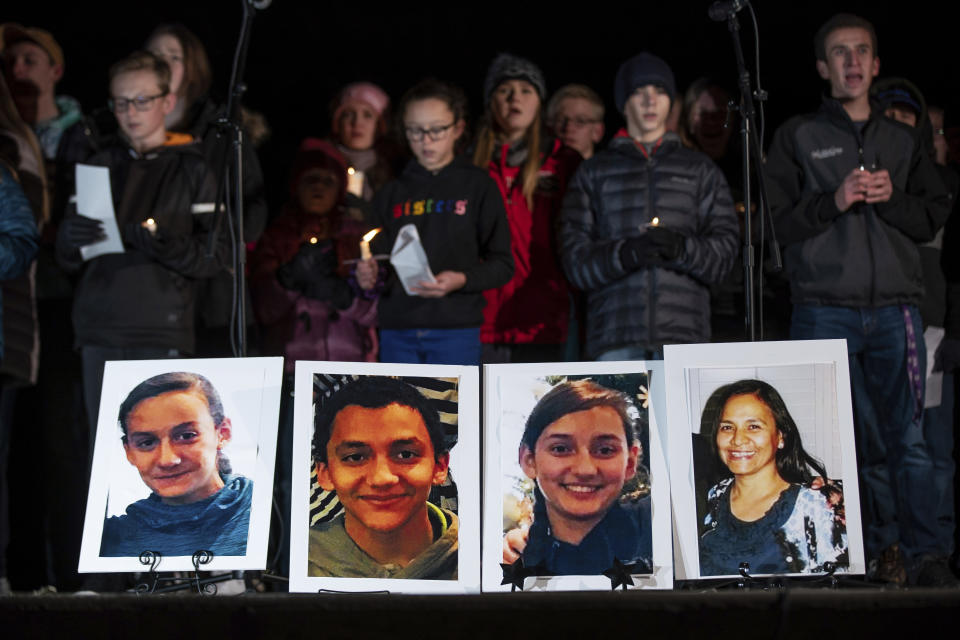 Photographs of Consuelo Alejandra Haynie, 52, right, and three of her children, 12-year-old Maylan, 14-year-old Mathew, and 15-year-old Alexis Haynie, left to right, are displayed at a candlelight vigil for the Haynie family at City Park in Grantsville, Utah, Monday, Jan. 20, 2020. Police say four members of the Haynie family were killed and one injured after being shot by a teenage family member on Jan. 17. (Spenser Heaps/The Deseret News via AP)