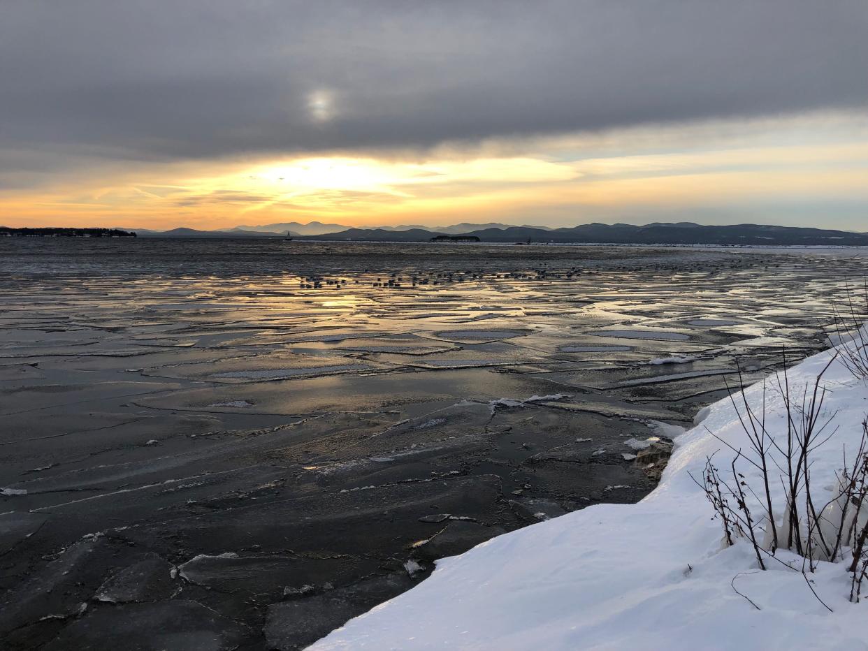 The sun sets over Lake Champlain where authorities have urged caution following the recent deaths of three fishers who fell through the ice in two separate incidents.