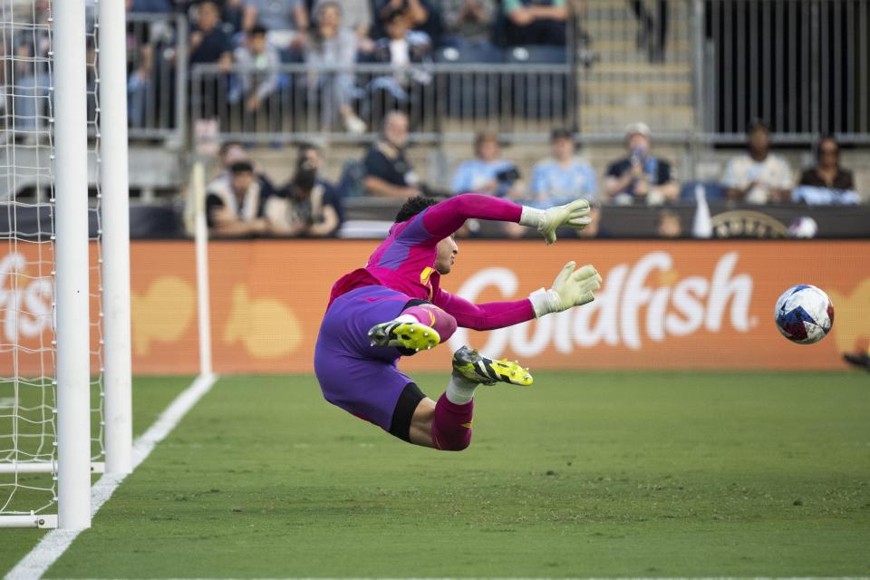 New England Revolution goalkeeper Jacob Jackson is unable to stop a goal by Philadelphia Union's Mikael Uhre during an MLS playoff soccer game, Saturday, Oct. 28, 2023, in Philadelphia. (AP Photo/Joe Lamberti)