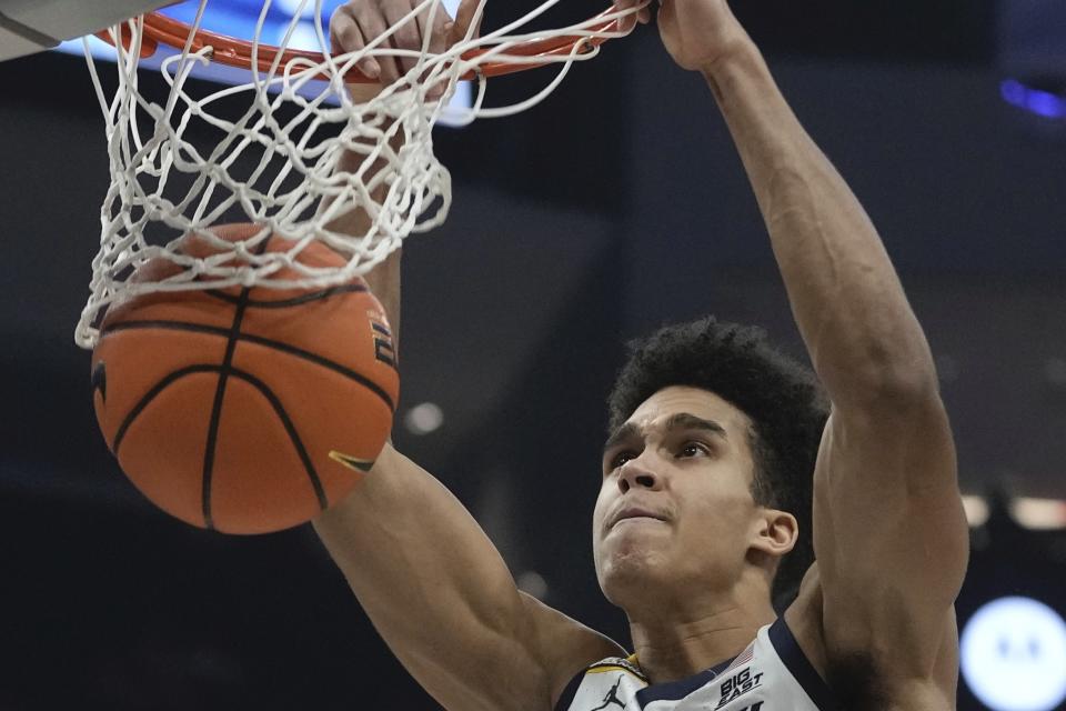 Marquette's Oso Ighodaro dunks during the first half of an NCAA college basketball game Wednesday, Feb. 21, 2024, in Milwaukee. (AP Photo/Morry Gash)